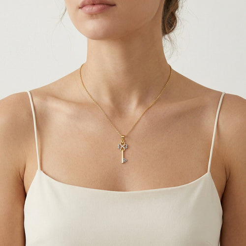 Colgante llave de amor trébol de cuatro hojas en oro bicolor