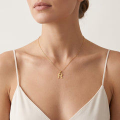 Gold pendant of letter R