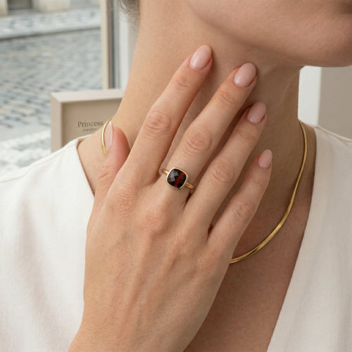 Garnet cushion cut in bar setting