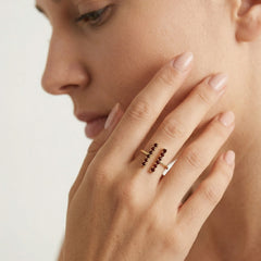 Gold ring with garnets along finger