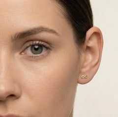 Lustrous yellow gold infinity stud earrings