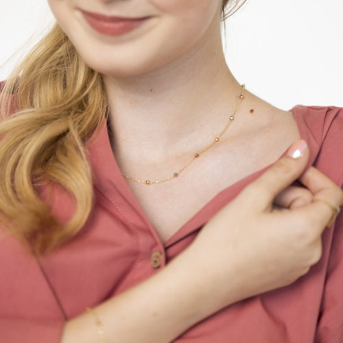 Golden necklace with ten golden marbles