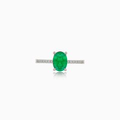 White gold ring with oval emerald and diamonds