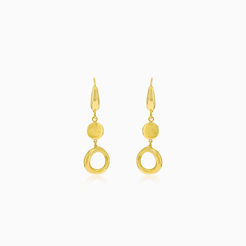 Boucles d'oreilles pendantes en or avec un cercle et une pièce.