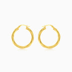 Twisted tube hoop earrings in yellow gold