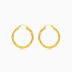 Twisted tube hoop earrings in yellow gold