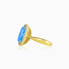 Masivní zlatý prsten s kabošonským modrým opálem